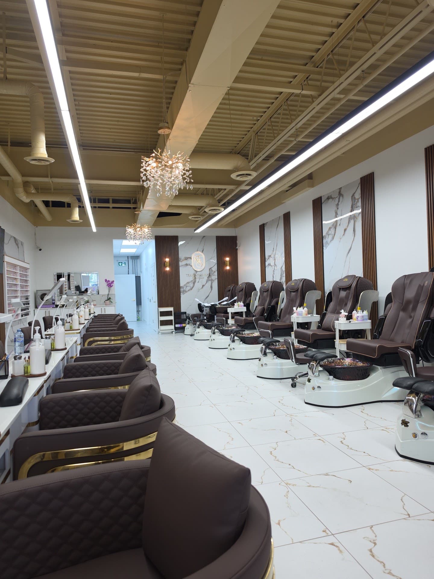 Pedicure lounge with espresso massage chairs and crystal chandeliers